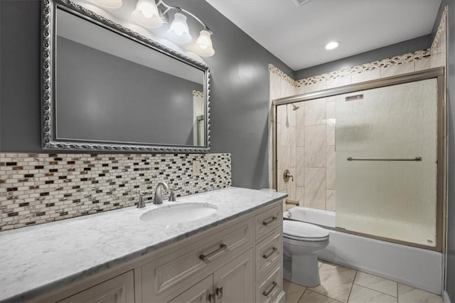 6608 N Edison Ave, Kansas City, MO 64151 - bathroom with toilet, vanity, shower / bath combination with glass door, marble look tiles, and backsplash