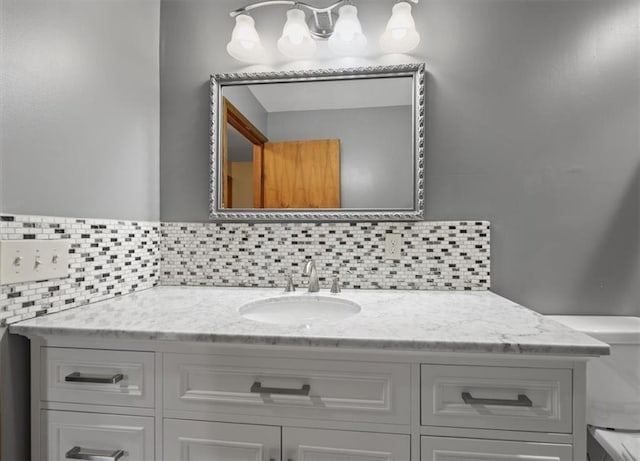6608 N Edison Ave, Kansas City, MO 64151 - bathroom with vanity, tasteful backsplash, and toilet