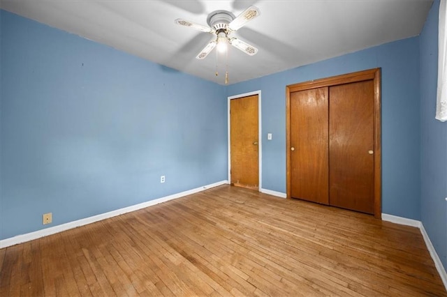 6608 N Edison Ave, Kansas City, MO 64151 - unfurnished bedroom with baseboards, hardwood / wood-style floors, and a ceiling fan