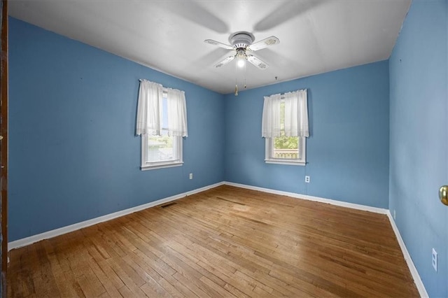 6608 N Edison Ave, Kansas City, MO 64151 - unfurnished room with ceiling fan, hardwood / wood-style floors, and baseboards