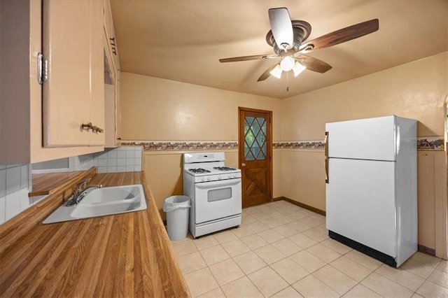 6608 N Edison Ave, Kansas City, MO 64151 - kitchen featuring white appliances, a sink, ceiling fan, butcher block counters, and light tile patterned flooring