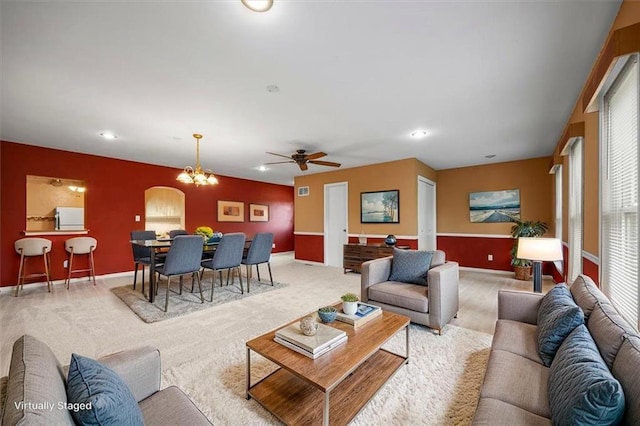 6608 N Edison Ave, Kansas City, MO 64151 - carpeted living room with recessed lighting, baseboards, ceiling fan, a chandelier, and arched walkways