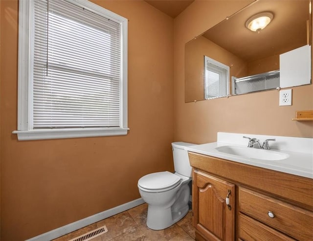 6608 N Edison Ave, Kansas City, MO 64151 - bathroom with toilet, vanity, baseboards, tile patterned flooring, and a shower