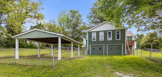 6608 N Edison Ave, Kansas City, MO 64151 - view of outbuilding featuring driveway, an attached garage, and a carport