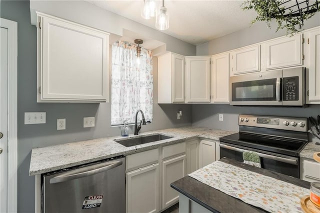 124 Wildwood St, Excelsior Springs, MO 64024 - kitchen with appliances with stainless steel finishes, a sink, white cabinets, and light stone countertops