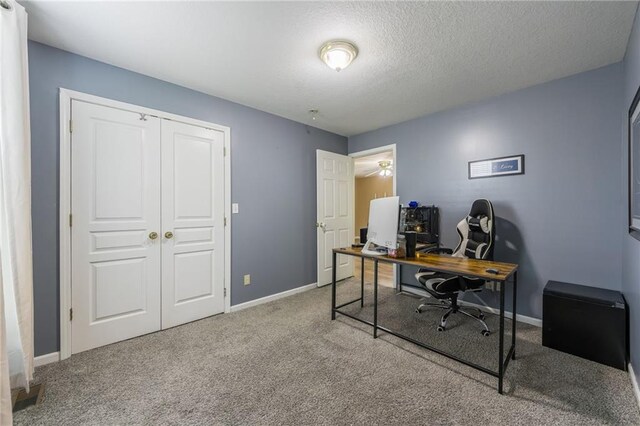 124 Wildwood St, Excelsior Springs, MO 64024 - carpeted home office featuring baseboards and a textured ceiling