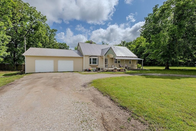3005 W W 8th St, Coffeyville, KS 67337 - view of front facade with a porch, an attached garage, metal roof, and driveway