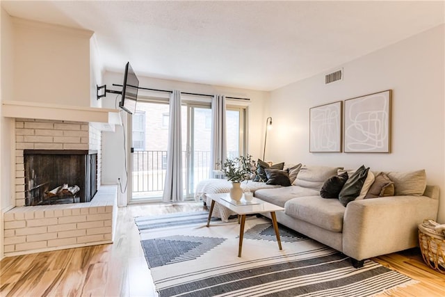 3606 Gillham Rd Unit 25, Kansas City, MO 64111 - living area with wood finished floors and a fireplace