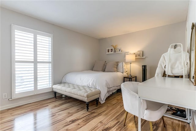 3606 Gillham Rd Unit 25, Kansas City, MO 64111 - bedroom with multiple windows and wood finished floors