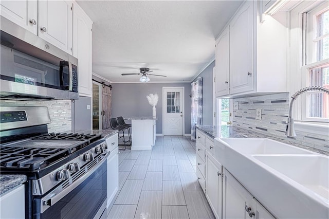 2200 E 126th St, Kansas City, MO 64146 - kitchen with appliances with stainless steel finishes, a sink, tasteful backsplash, white cabinets, and ornamental molding