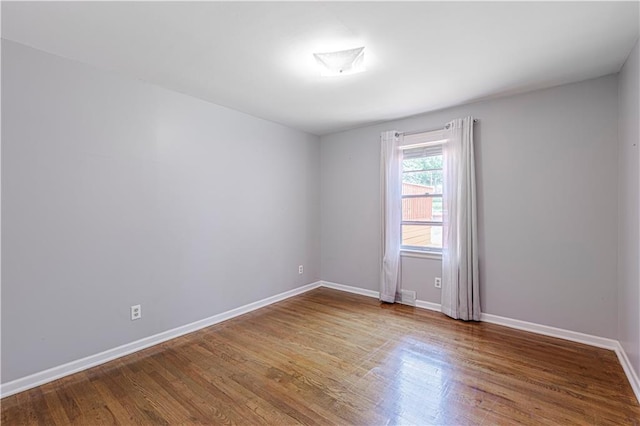 2200 E 126th St, Kansas City, MO 64146 - empty room with wood finished floors and baseboards