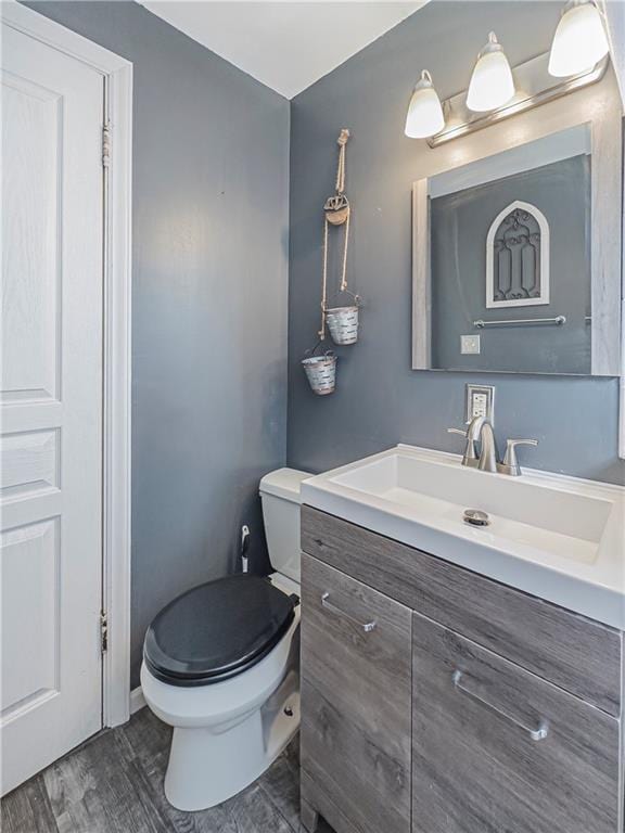 2200 E 126th St, Kansas City, MO 64146 - half bathroom with vanity, toilet, and wood finished floors
