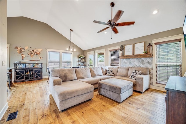 12301 White Oak St, Peculiar, MO 64078 - living room featuring a ceiling fan, light wood finished floors, healthy amount of natural light, high vaulted ceiling, and a chandelier