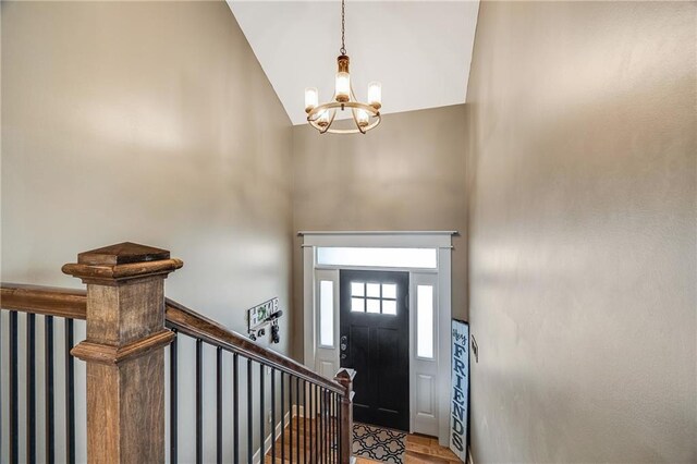 12301 White Oak St, Peculiar, MO 64078 - foyer with high vaulted ceiling, a chandelier, and wood finished floors