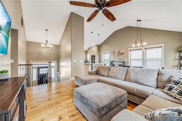 12301 White Oak St, Peculiar, MO 64078 - living area featuring a chandelier, ceiling fan, high vaulted ceiling, hardwood / wood-style floors, and healthy amount of natural light