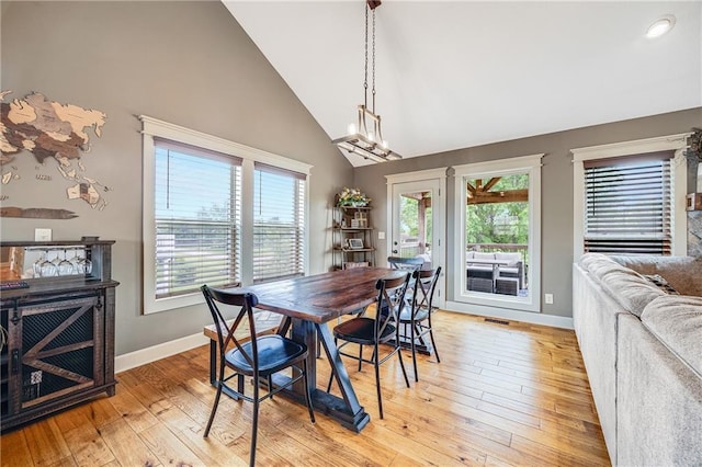 12301 White Oak St, Peculiar, MO 64078 - dining area featuring high vaulted ceiling, baseboards, healthy amount of natural light, and light wood-style flooring