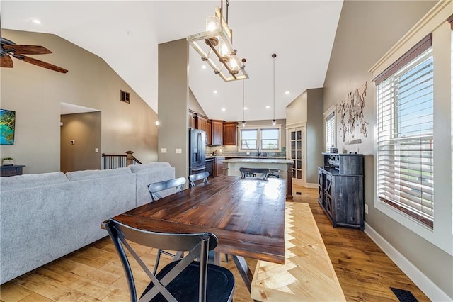 12301 White Oak St, Peculiar, MO 64078 - dining area with light wood-type flooring, a ceiling fan, high vaulted ceiling, recessed lighting, and baseboards
