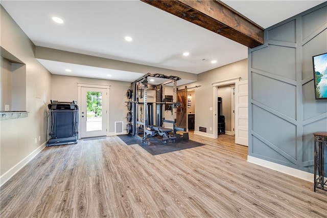 12301 White Oak St, Peculiar, MO 64078 - workout area with a barn door, light wood-style flooring, baseboards, and recessed lighting