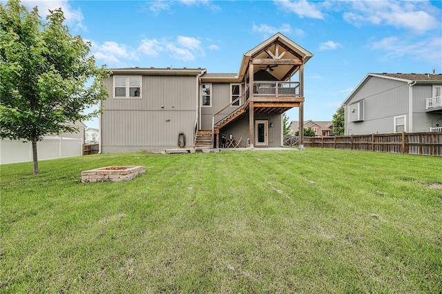 12301 White Oak St, Peculiar, MO 64078 - back of property with an outdoor fire pit, stairway, ceiling fan, and a deck