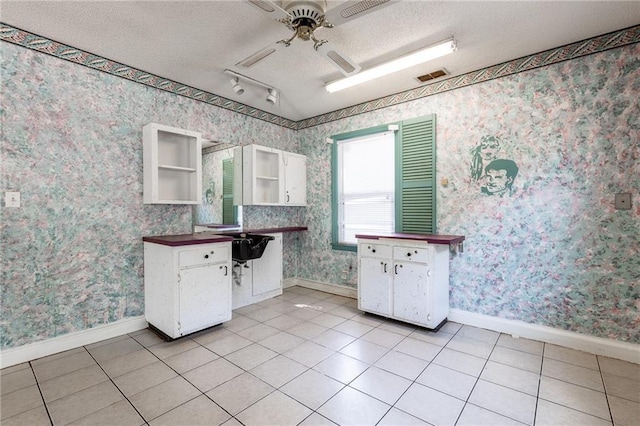 7001 Hunter St, Raytown, MO 64133 - kitchen featuring open shelves, baseboards, a ceiling fan, wallpapered walls, and a textured ceiling