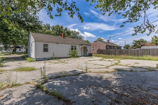7001 Hunter St, Raytown, MO 64133 - back of property with a chimney and central air condition unit