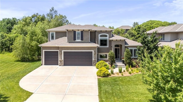 11446 S Longview Rd, Olathe, KS 66061 - view of front of house with concrete driveway, a front lawn, a garage, and stucco siding