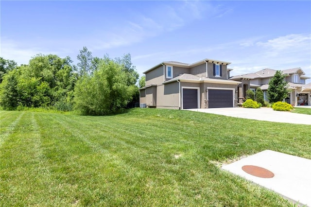11446 S Longview Rd, Olathe, KS 66061 - view of front of house with concrete driveway, a front lawn, and a garage