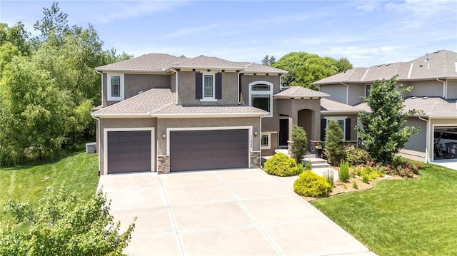 11446 S Longview Rd, Olathe, KS 66061 - view of front of house with a garage, driveway, a front yard, and stucco siding