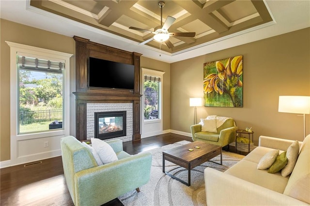 11446 S Longview Rd, Olathe, KS 66061 - living room with dark wood-style floors, healthy amount of natural light, a fireplace, a ceiling fan, and coffered ceiling
