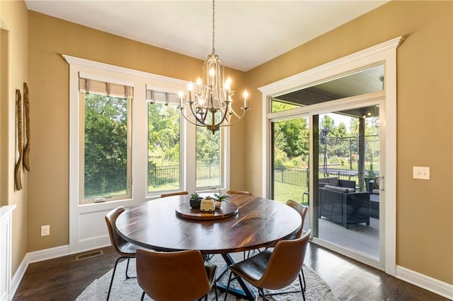 11446 S Longview Rd, Olathe, KS 66061 - dining space with a chandelier, dark wood-style flooring, and healthy amount of natural light