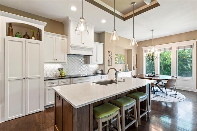 11446 S Longview Rd, Olathe, KS 66061 - kitchen with black electric cooktop, tasteful backsplash, dark wood-style flooring, white cabinets, and recessed lighting