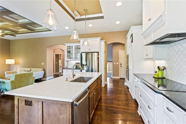 11446 S Longview Rd, Olathe, KS 66061 - kitchen with arched walkways, stainless steel appliances, custom exhaust hood, recessed lighting, and backsplash