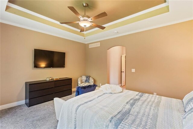 11446 S Longview Rd, Olathe, KS 66061 - bedroom featuring a raised ceiling, arched walkways, carpet floors, ornamental molding, and a ceiling fan