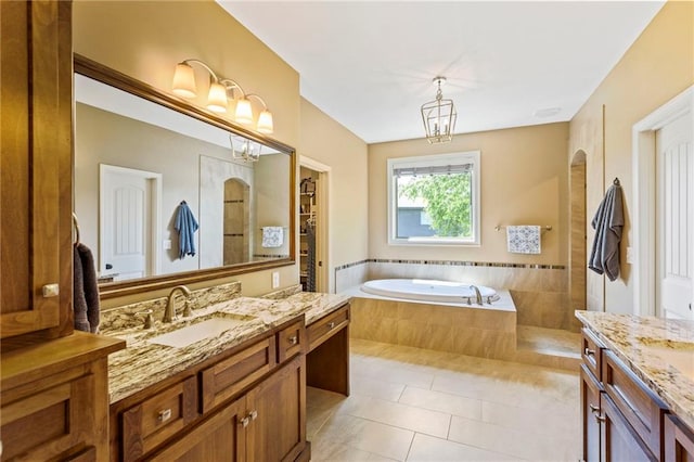 11446 S Longview Rd, Olathe, KS 66061 - full bath with two vanities, a bath, tile patterned floors, and a chandelier