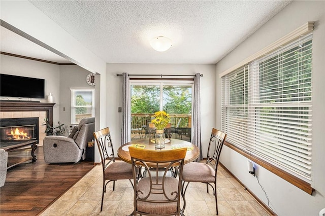 16519 E 53rd Street Ct, Independence, MO 64055 - dining room featuring a fireplace and a textured ceiling
