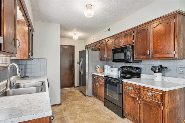 16519 E 53rd Street Ct, Independence, MO 64055 - kitchen featuring black appliances, a sink, a textured ceiling, tasteful backsplash, and light countertops