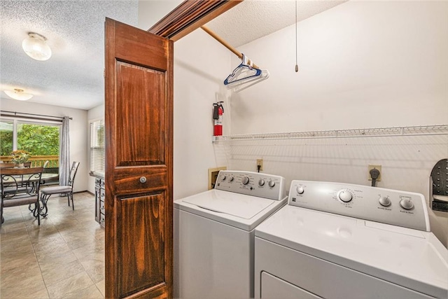16519 E 53rd Street Ct, Independence, MO 64055 - laundry room featuring washer and clothes dryer and a textured ceiling