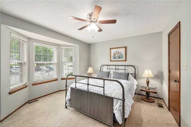 16519 E 53rd Street Ct, Independence, MO 64055 - bedroom with light colored carpet, baseboards, a textured ceiling, and a ceiling fan