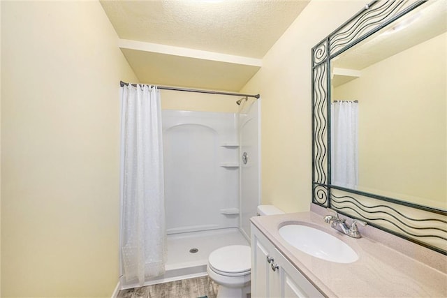 16519 E 53rd Street Ct, Independence, MO 64055 - bathroom featuring toilet, vanity, a shower with curtain, wood finished floors, and a textured ceiling