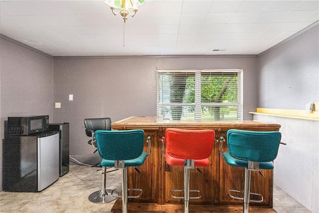 16519 E 53rd Street Ct, Independence, MO 64055 - indoor dry bar with a textured wall and freestanding refrigerator