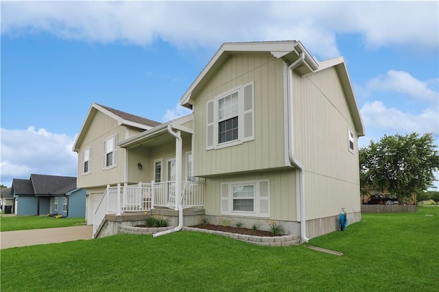 156 SE 1181st Rd, Knob Noster, MO 65336 - view of front of home with a garage, a front yard, driveway, and covered porch