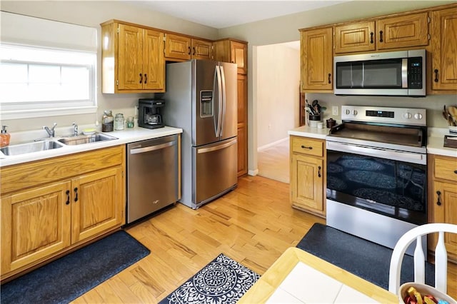 156 SE 1181st Rd, Knob Noster, MO 65336 - kitchen with stainless steel appliances, a sink, light countertops, and light wood-style flooring