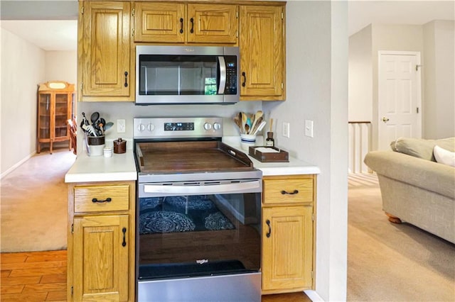 156 SE 1181st Rd, Knob Noster, MO 65336 - kitchen with appliances with stainless steel finishes, light colored carpet, light countertops, and baseboards