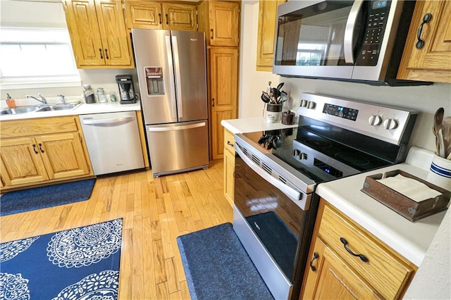 156 SE 1181st Rd, Knob Noster, MO 65336 - kitchen featuring stainless steel appliances, a sink, light wood-type flooring, and light countertops