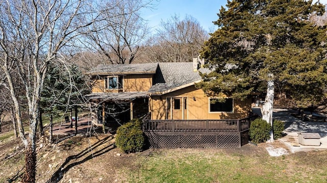 22450 Hatchell Rd, Tonganoxie, KS 66086 - view of front facade with a shingled roof, a deck, and a chimney