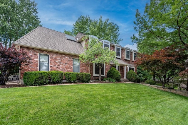 13008 Fontana St, Leawood, KS 66209 - view of front of home featuring a front yard, roof with shingles, and brick siding