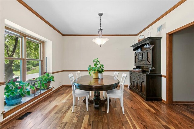 13008 Fontana St, Leawood, KS 66209 - dining space featuring hardwood / wood-style flooring, crown molding, and baseboards