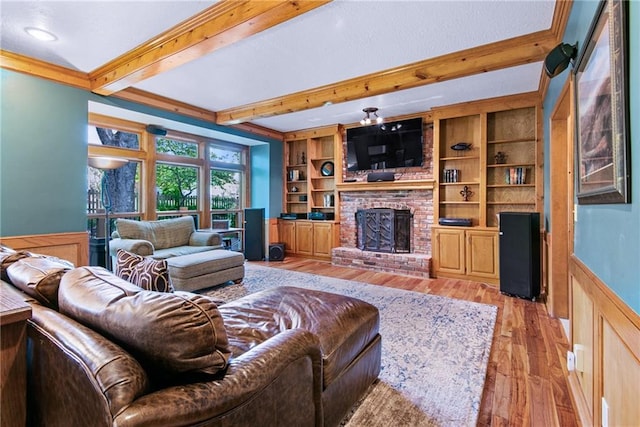 13008 Fontana St, Leawood, KS 66209 - living area with beam ceiling, a brick fireplace, light wood-type flooring, ornamental molding, and a wainscoted wall