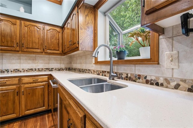 13008 Fontana St, Leawood, KS 66209 - kitchen with a sink, brown cabinets, light countertops, and decorative backsplash