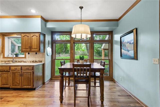 13008 Fontana St, Leawood, KS 66209 - dining room featuring ornamental molding, plenty of natural light, and light wood-type flooring